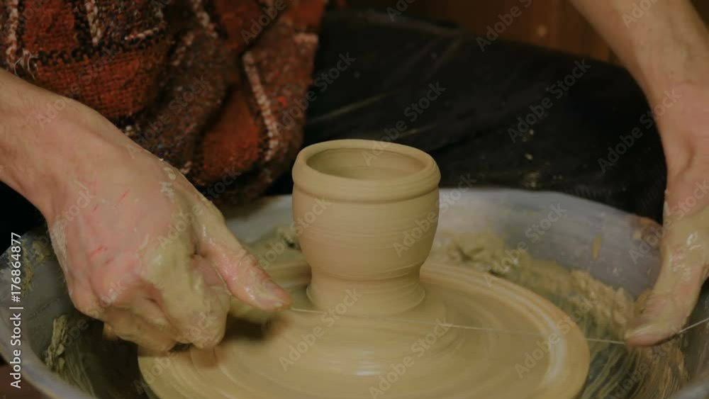 Professional male potter working in workshop, studio. Handmade, small business, crafting work concept