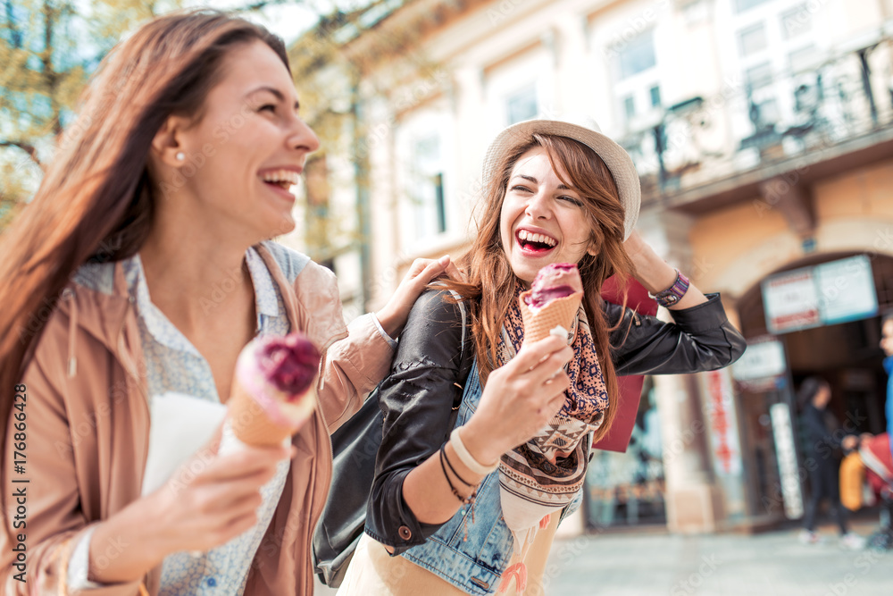 Two best friends having ice cream together outdoors. Two best friends having ice cream together outdoors.