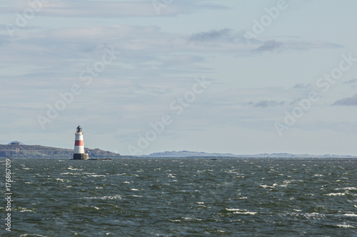 Lighthouse on the sea at sunny day