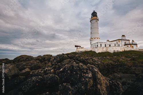Old lighthouse on the rock coast of sea