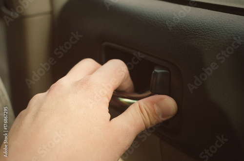 Man hand opens car door from indoor close up. Road safety. Car travel.