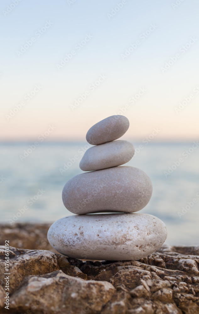 Pile of Stones on Tranquil Beach at Sunset Pile of Stones on Tranquil Beach at Sunset