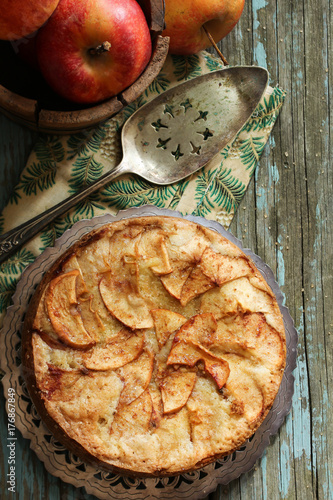 Homemade German apple cake on rustic blue wooden background,Top Down view / Thanksgiving dessert photo