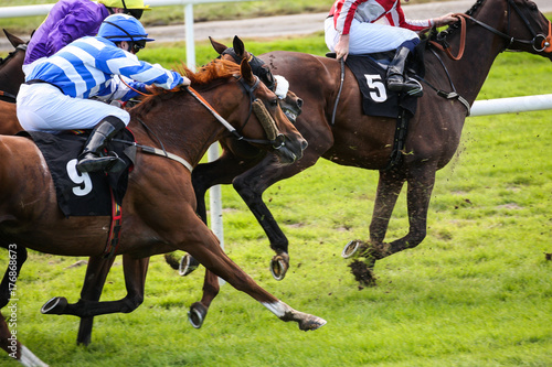 Jockeys and Race horses in intense competition