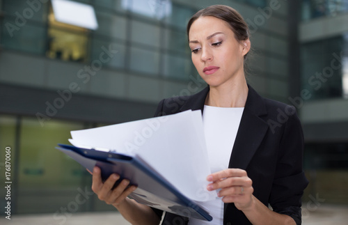 Woman is examining documents © JackF