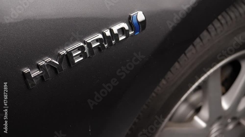 Focus is made on the Hybrid badge of a car. photo