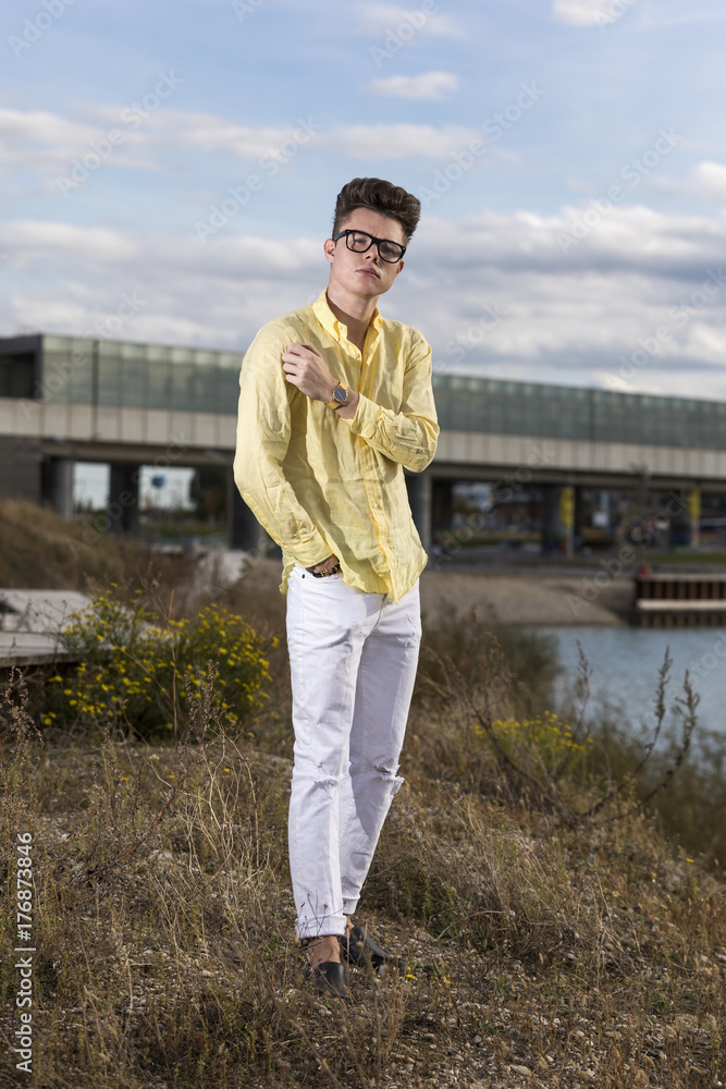 Handsome young man wearing jeans and glasses Handsome young man wearing jeans and glasses