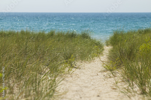 Fototapeta Naklejka Na Ścianę i Meble -  secluded beach path for travel lonely beach vacation.  Copyspace for words.