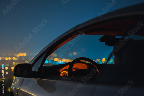 The car on the background of the city lights. evening night time photo