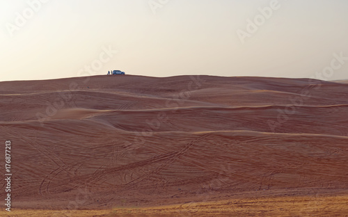 Safari vehicle on the skyline at sunset in the desert outsideDubai City  United Arab Emirates