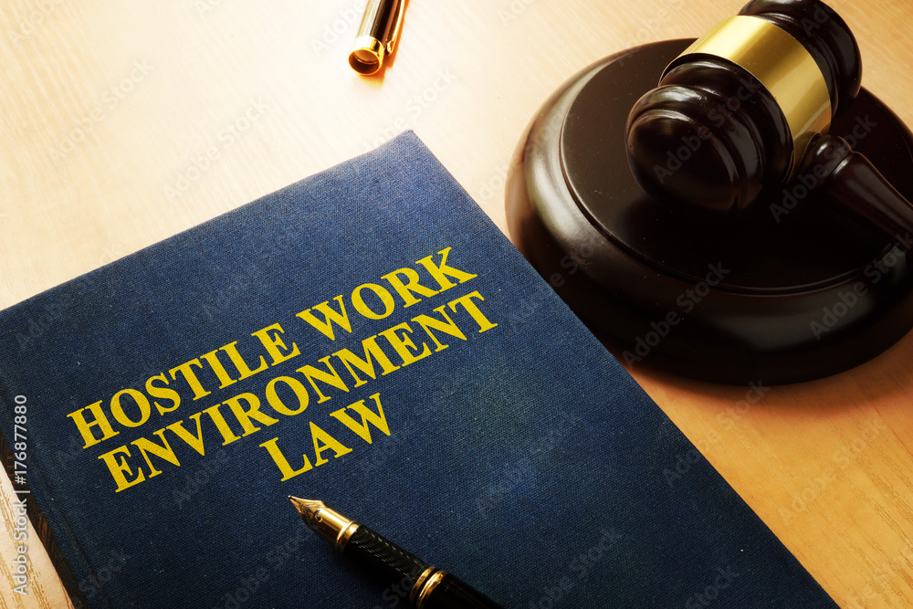 Hostile work environment law on an office table. Hostile work environment law on an office table.