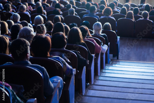 People in the auditorium during the performance. A theatrical production.