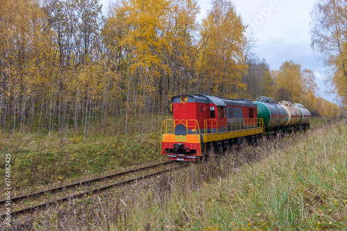 old locomotive with tanks in the autumn forest