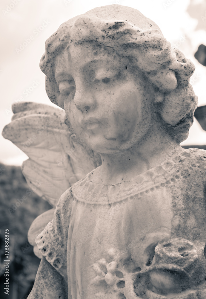 Statue of a baby angel in black and white