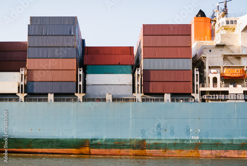 Cargo ship carrying many stacked containers to international port