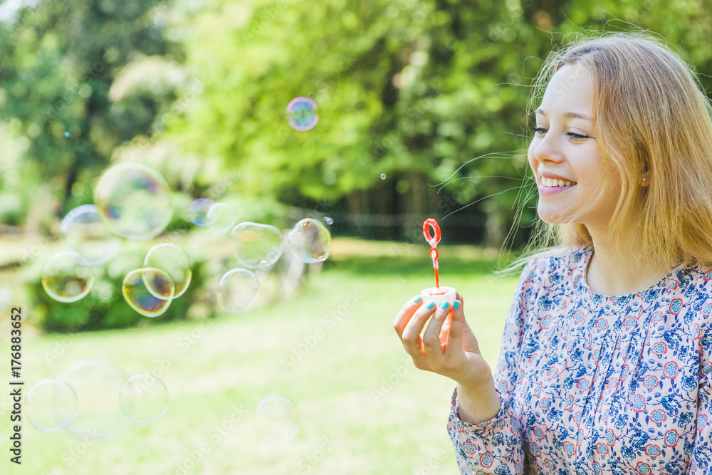 Cute Teen Girl Playing with Bubbles in a Park Cute Teen Girl Playing with Bubbles in a Park