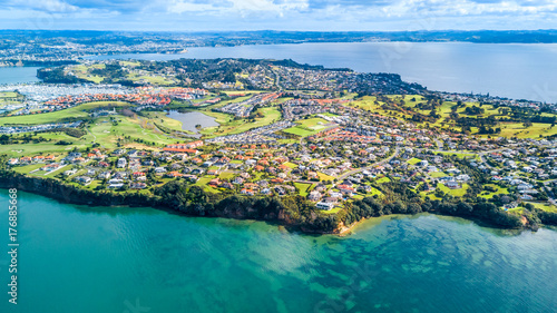 Aerial view on residential suburbs surrounded by sunny ocean harbour. Whangaparoa peninsula, Auckland, New Zealand © Dmitri