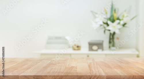 Real wood table top texture on white wall room background.For create product display or key visual layout
