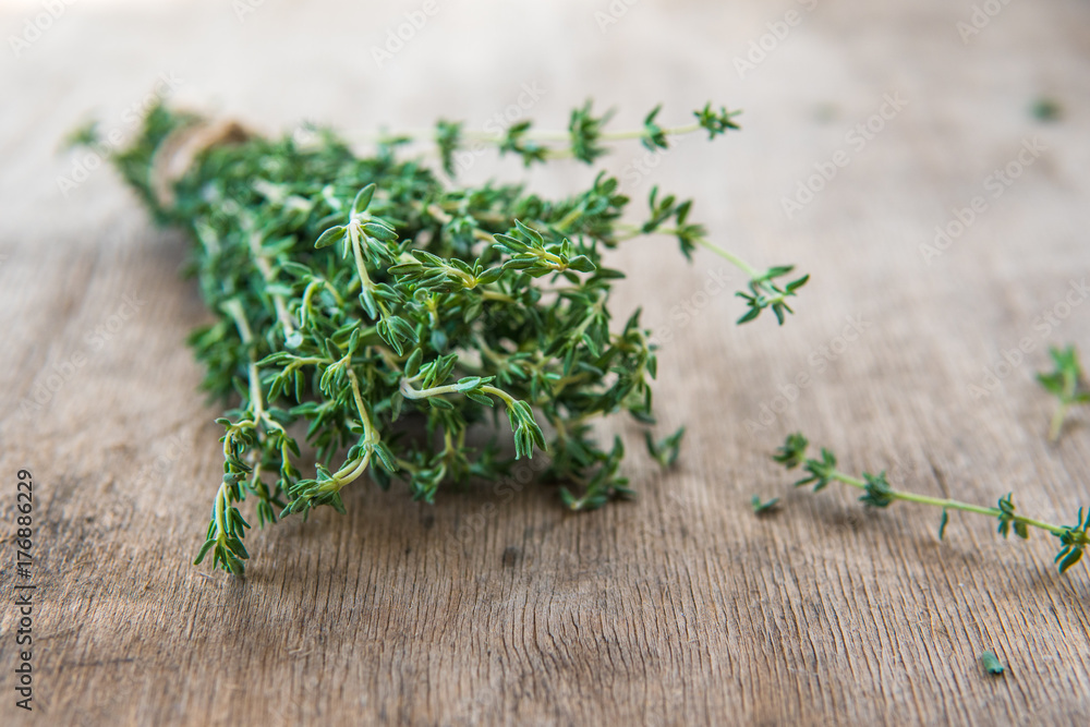 Thyme bunch. Bundle of fresh thymes on a wooden background Thyme bunch. Bundle of fresh thymes on a wooden background