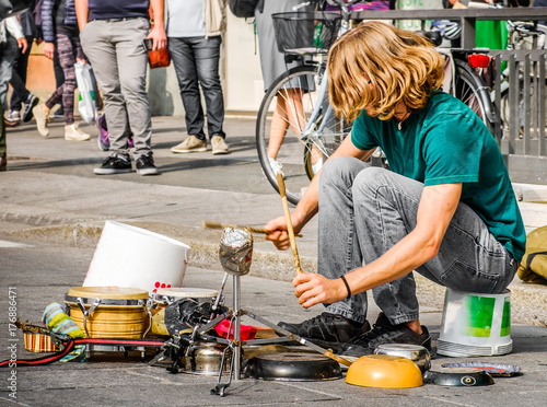 percussionist use pots and pans to play drums - busker street artist musician.