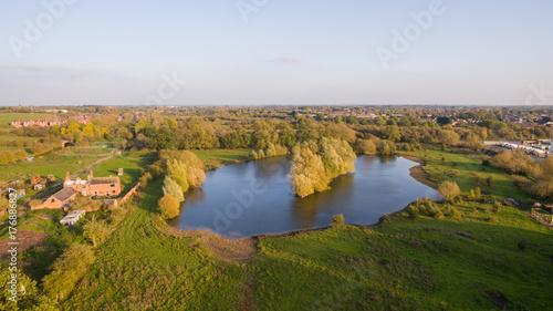 Aerial view over a lake in a park in the countryside © Anthony