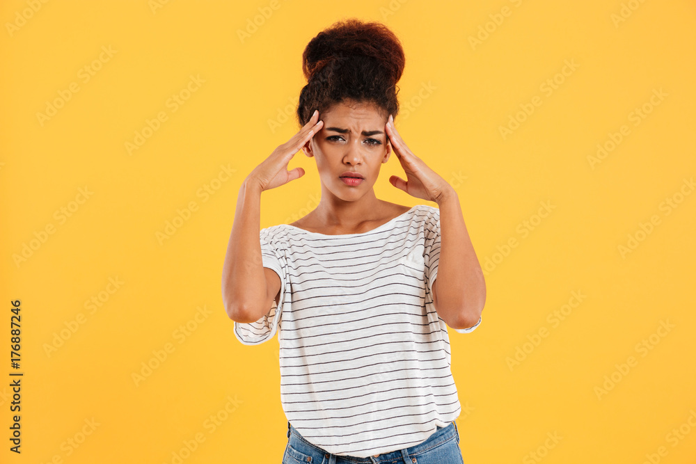 Young woman holding her head while headache Young woman holding her head while headache