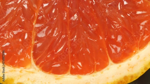 ripe grapefruit. Red color citrus fruit, rotates around the axis. Macro, studio light, advertising semk. photo