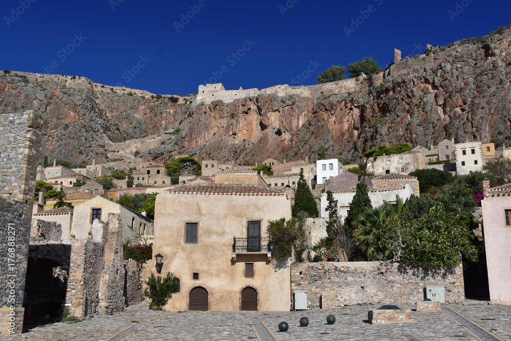 Situate on the tiny island - `The Rock` the old town of Monemvasia, Peloponnese, Greece with its charming streets and the old fortress on the vertical cliffs above it