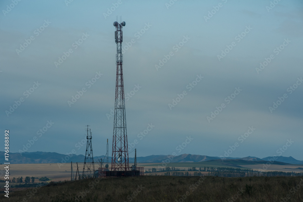 Telecommunications cell phone tower with antennas in a mountain location. Telecommunications cell phone tower with antennas in a mountain location.