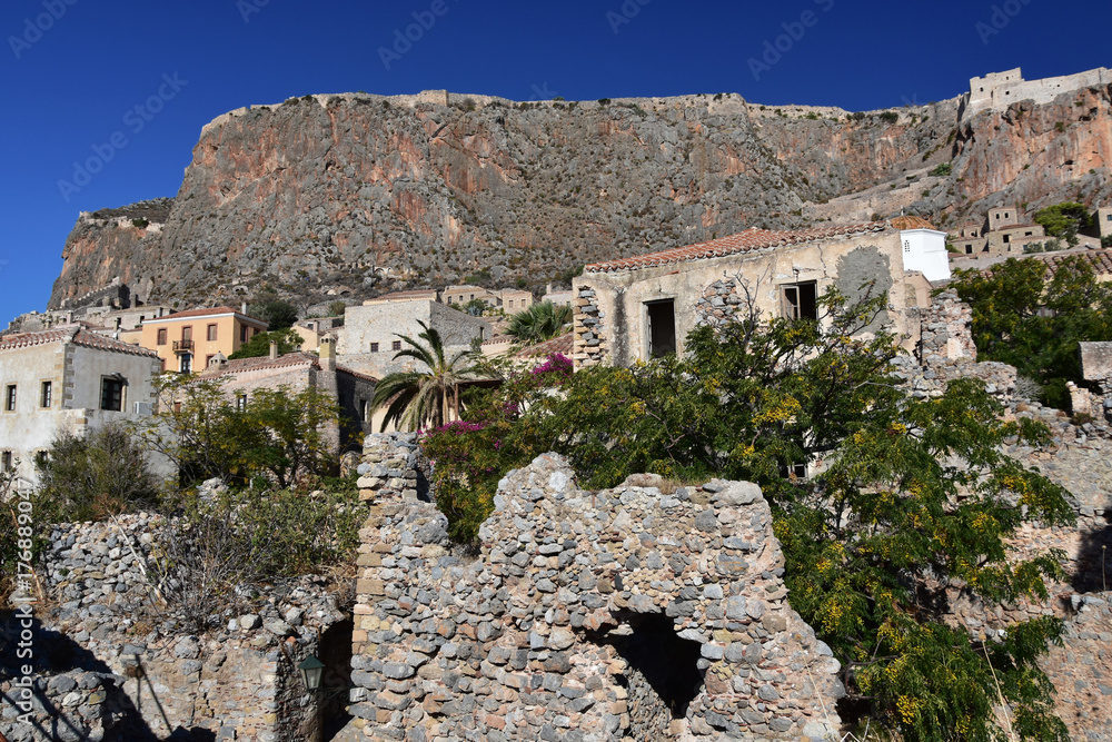 Situate on the tiny island - `The Rock` the old town of Monemvasia, Peloponnese, Greece with its charming streets and the old fortress on the vertical cliffs above it