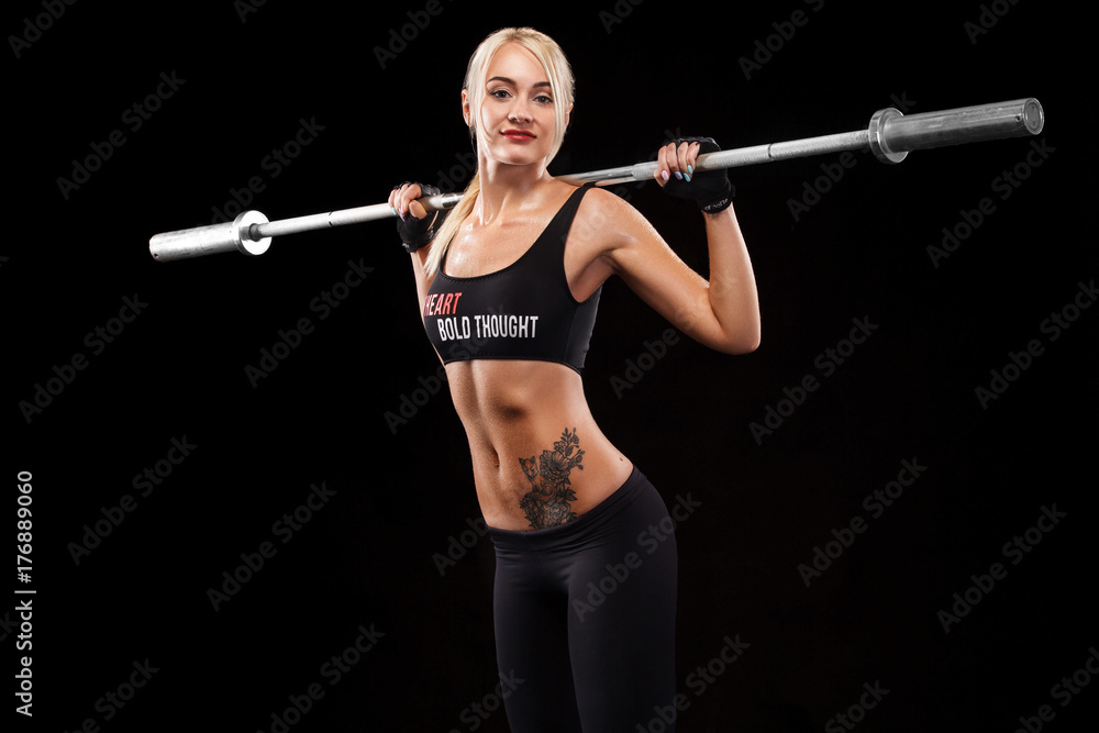 Sporty beautiful woman doing fitness exercising at black background to stay fit. Fitness workout motivation. Sporty beautiful woman doing fitness exercising at black background to stay fit. Fitness workout motivation.