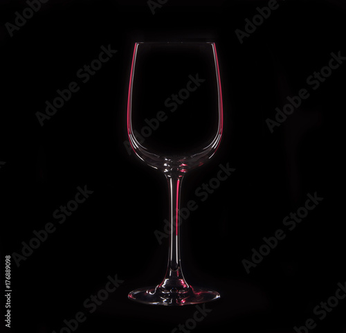 Silhouette of wineglass with red illumination