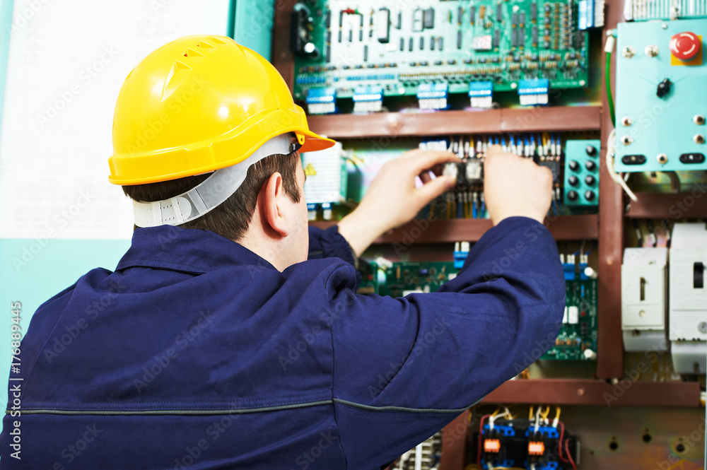 adult electrician builder engineer worker testing electronics in switch board adult electrician builder engineer worker testing electronics in switch board