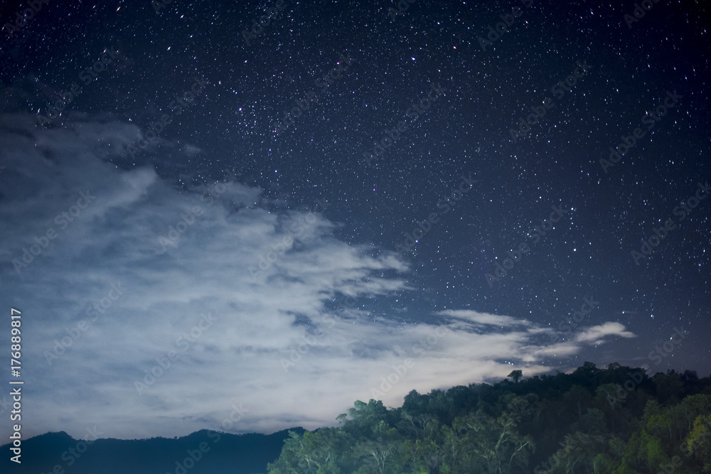Beautiful night scape with dark blue sky with a lot of star white cloud and the green mountain. View from the village in the forest at the north part of Thailand. Beautiful night scape with dark blue sky with a lot of star white cloud and the green mountain. View from the village in the forest at the north part of Thailand.