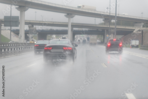 highway junction at the middle of the day. clouds and rain. Seeing as there's heavy shower on a highway and road condition looks quite dangerous. Moscow © Mak