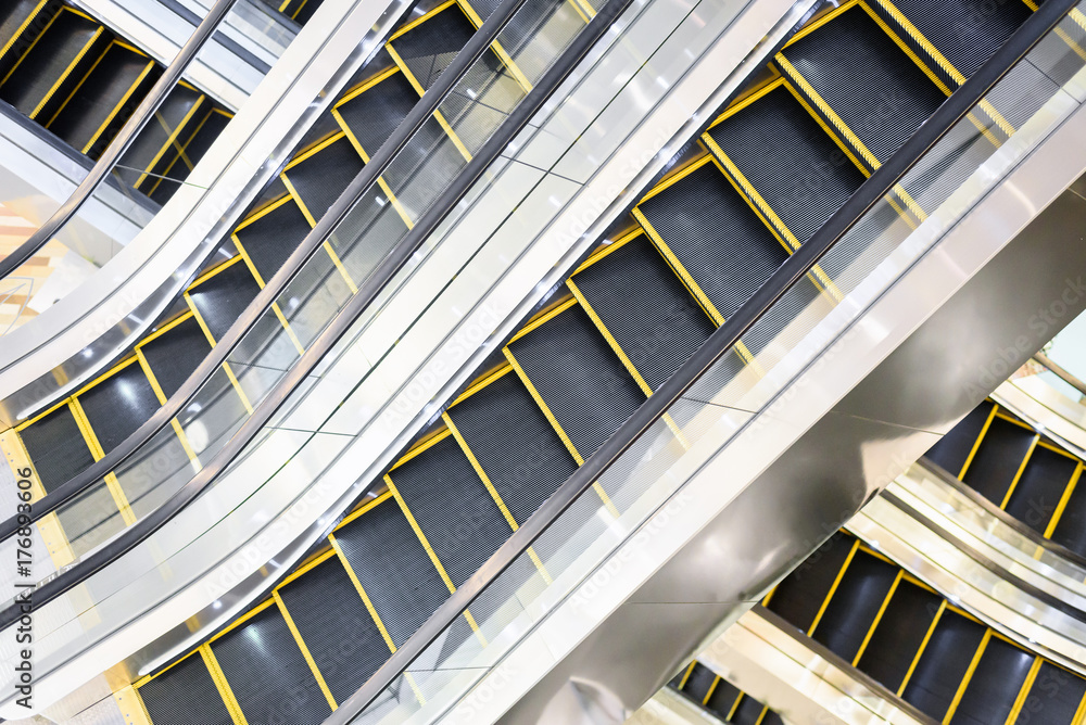 Fototapeta premium The multiple steps and directions of an escalator in the modern shopping mall