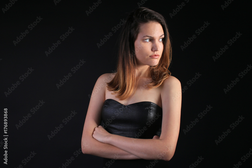 Seductive girl in a black dress looking away Seductive girl in a black dress looking away