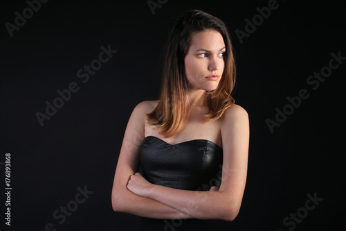 Seductive girl in a black dress looking away