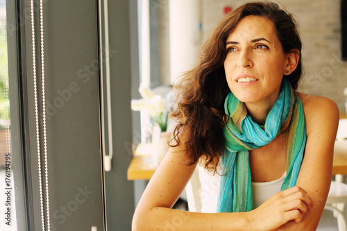 Portrait of beautiful 40 years old woman sitting in the cafe photo