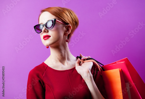 woman in sunglasses with shopping bags