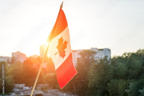 Flag of Canada from window sunset background