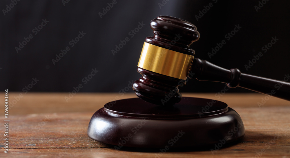 Judge or auction gavel on a wooden desk