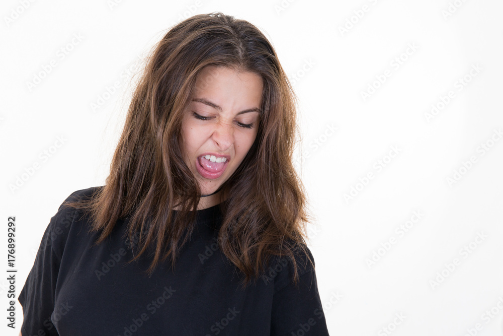 cute brunette girl looks down with a face that expresses the disgust cute brunette girl looks down with a face that expresses the disgust