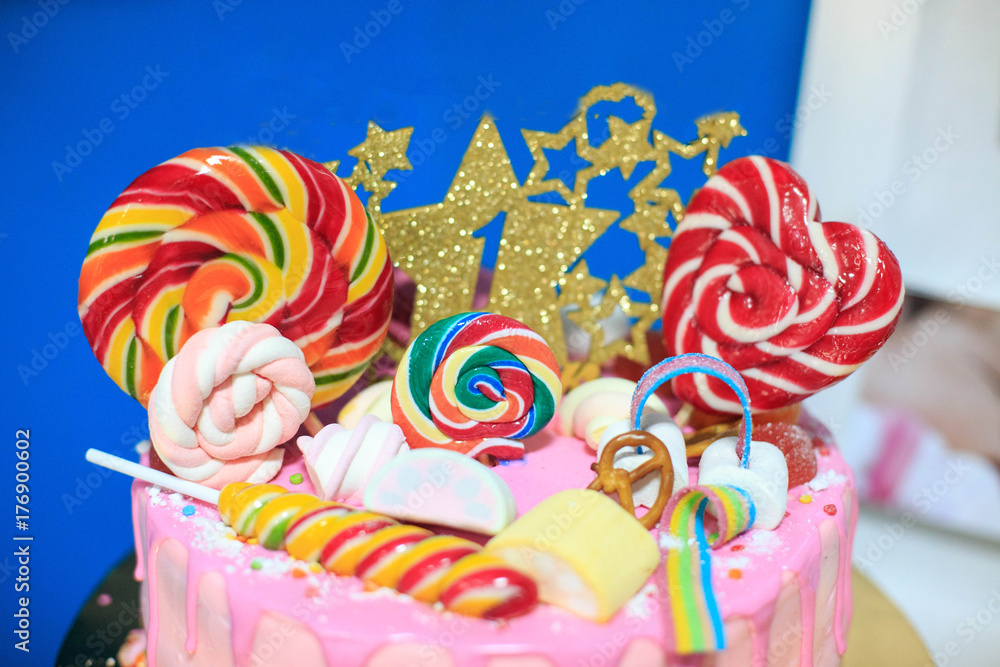 Cake with lollipops and marshmallow. Concept birthday party, childhood.