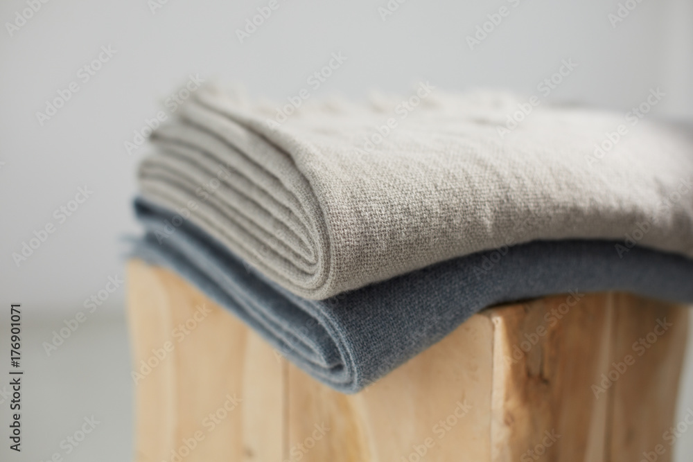 Two wool blankets on a wooden stool Two wool blankets on a wooden stool