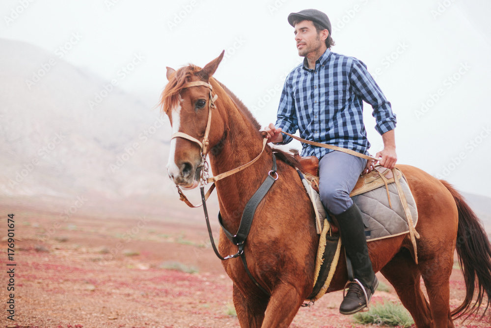 A man and his horse walk through the desert landscape A man and his horse walk through the desert landscape