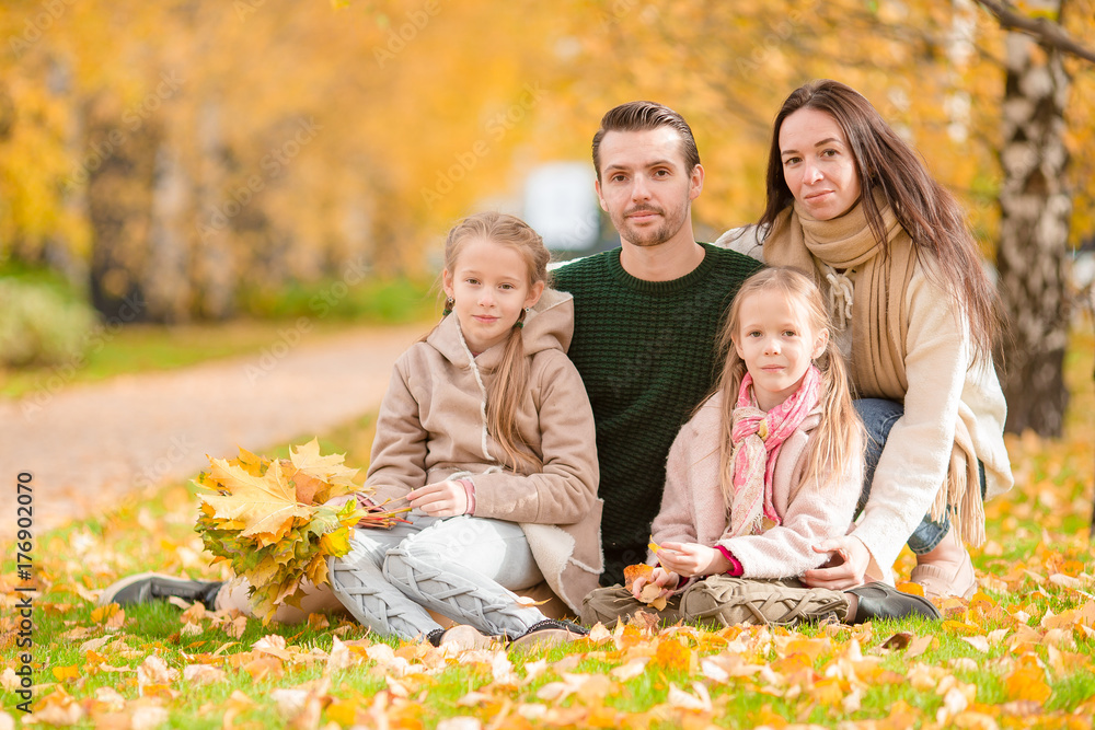 Beautiful happy family of four in autumn day outdoors Beautiful happy family of four in autumn day outdoors