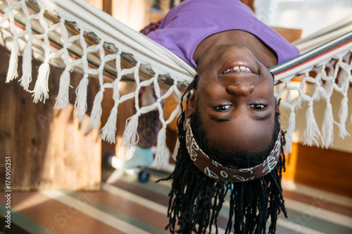 African American girl laying on a hammock upside down photo