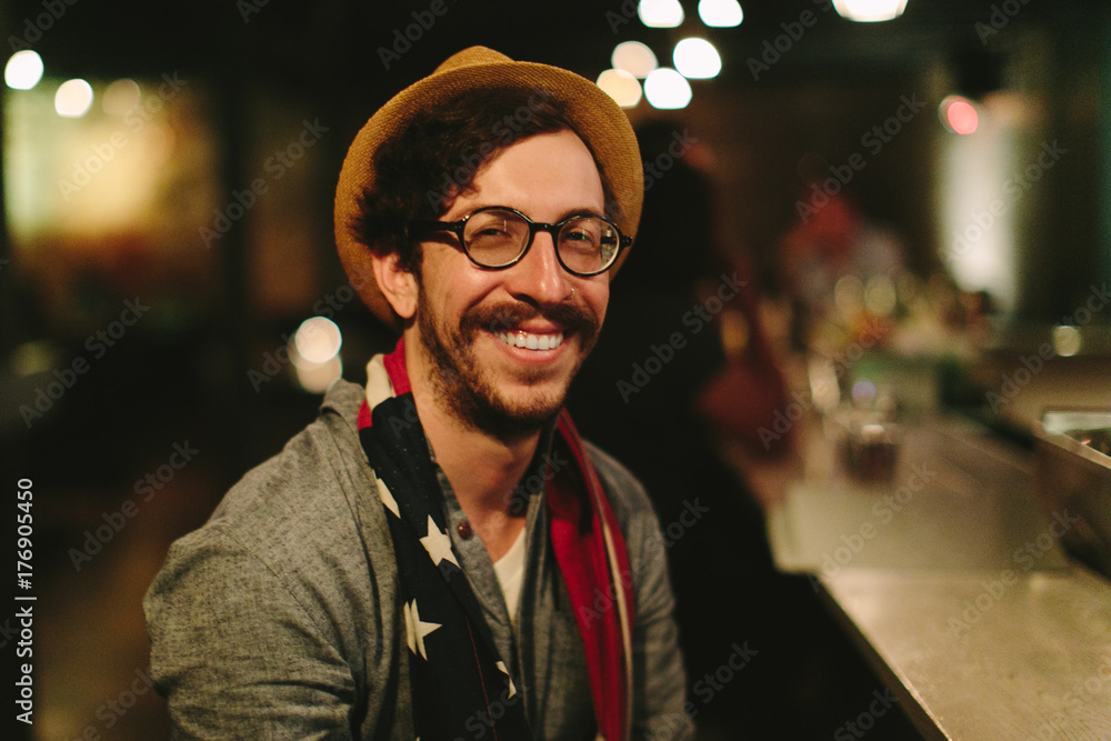 Portrait of a smiling man wearing a fedora and an american flag scarf Portrait of a smiling man wearing a fedora and an american flag scarf