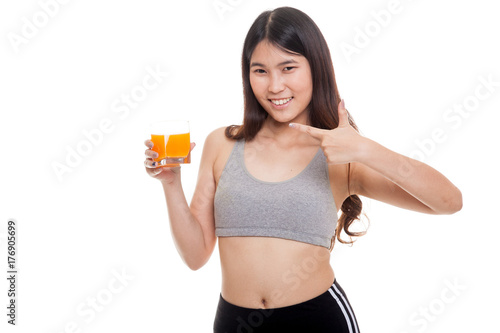 Beautiful Asian healthy girl point to orange juice.